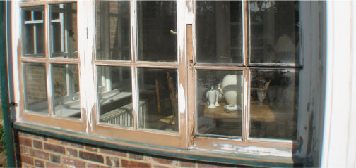 A picture of a window in a brick building undergoing sash window restoration.